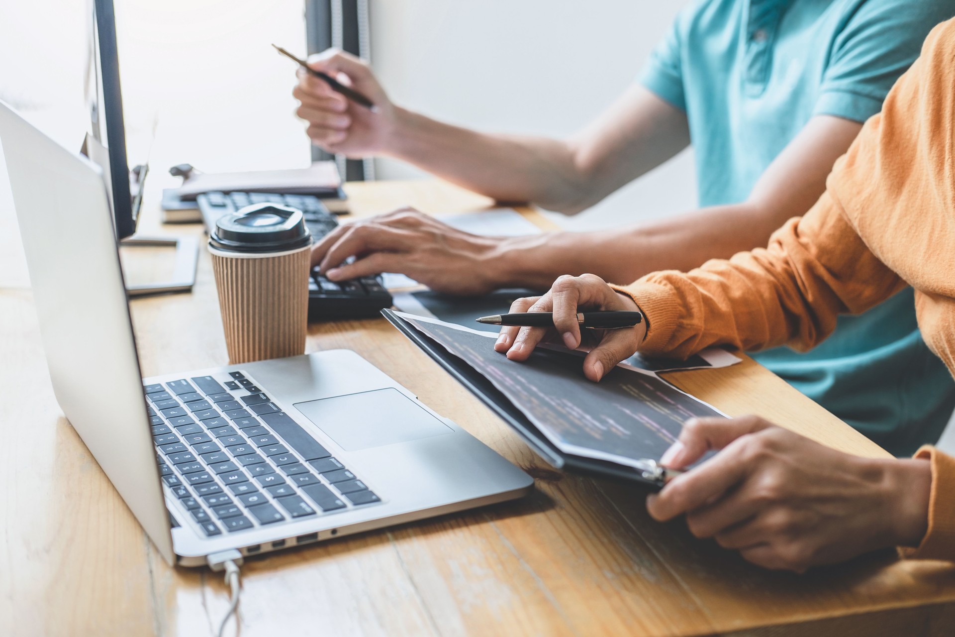 Programmers cooperating at Developing programming and website working in a software develop company office, writing codes and typing data code, Programming with HTML, PHP and javascript